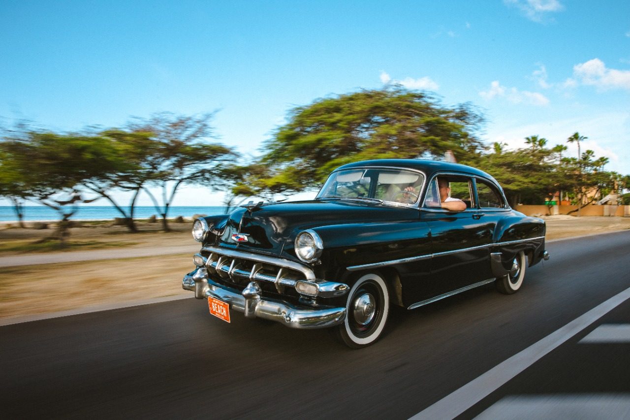 Black classic cruising the Aruba coast road